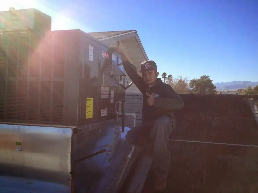 HVAC technician performing HVAC Inspection on a rooftop unit in Chester